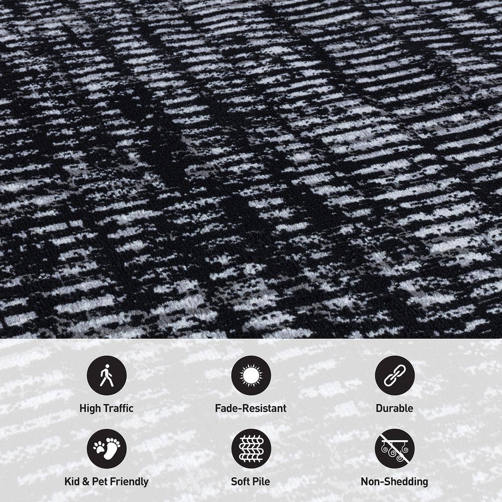 Black and Ivory Geometric Polypropylene Area Rug 2' x 7'