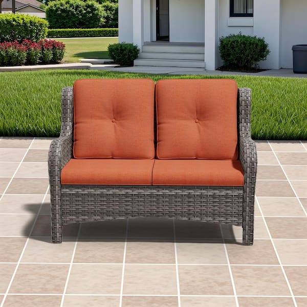 Brown Wicker Outdoor Patio Loveseat with Orange Cushions