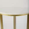 Close-up of the white marble tabletop and gold metal rim.