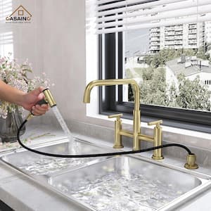 Double Handle Bridge Kitchen Faucet with Pull-Out Side Sprayer in Brushed Gold