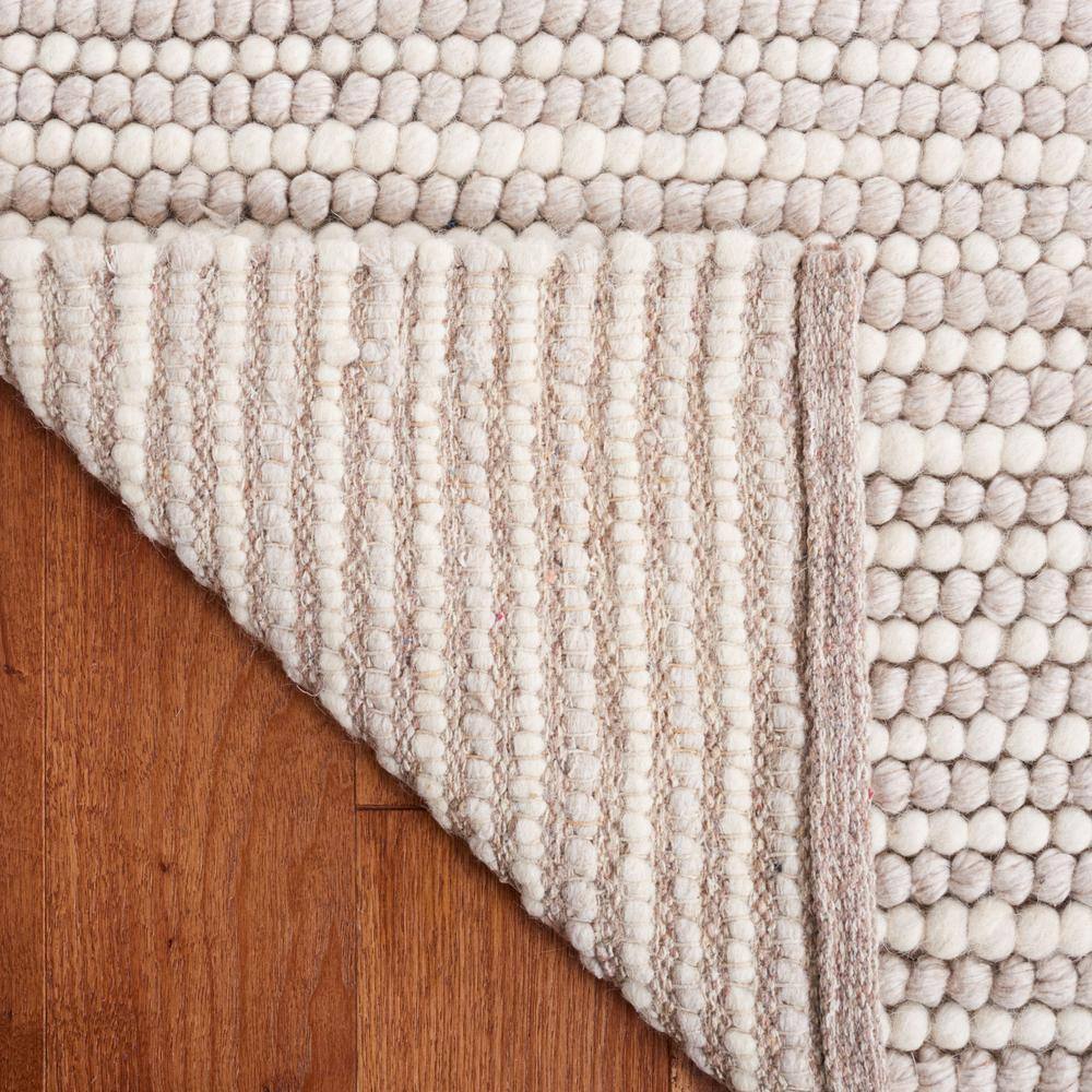 Ivory and Beige 8' x 10' Handwoven Wool and Synthetic Area Rug