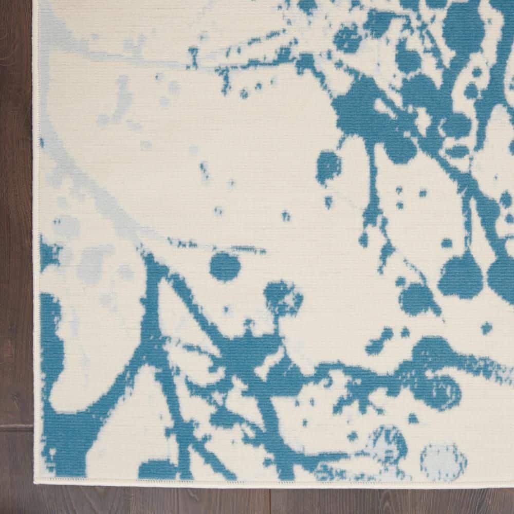 Ivory and Blue Abstract Synthetic 4' x 6' Easy-Care Area Rug