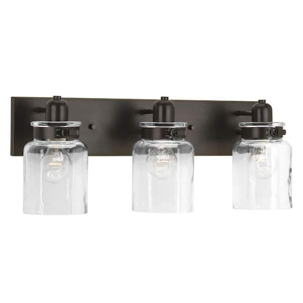 Calhoun Collection 21-5/8 in. 3-Light Antique Bronze Clear Glass Farmhouse Urban Industrial Bathroom Vanity Light