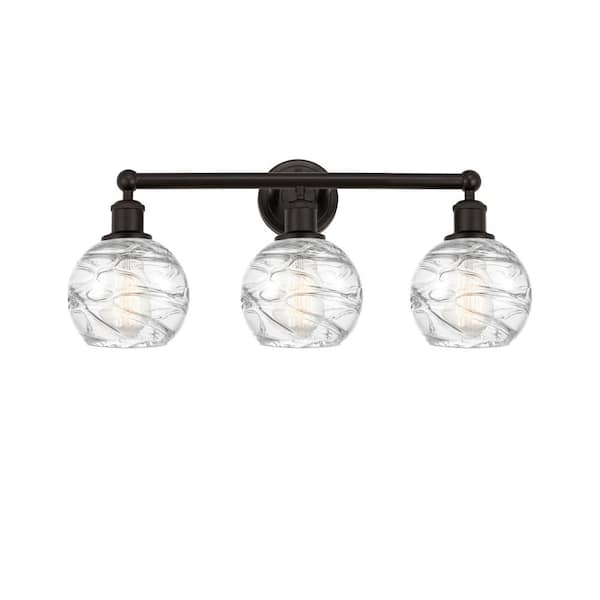Athens Deco Swirl 24 in. 3-Light Oil Rubbed Bronze, Clear Deco Swirl Vanity Light with Clear Glass Shade