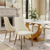 Dining set with white table and four beige upholstered chairs in a room setting.