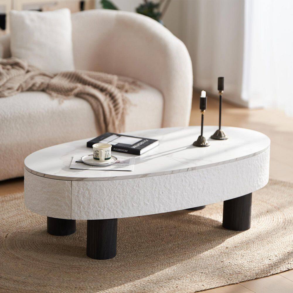 White coffee table with reading materials in a living room.