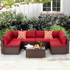 7-Piece Wicker Outdoor Sectional Set with Glass Table Red Cushions and Pillows