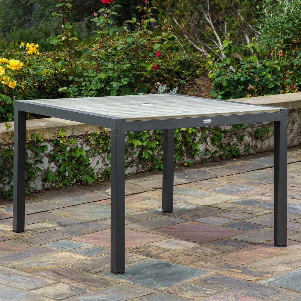 Square aluminum patio table with a light grey slatted top