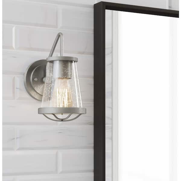 Georgina 5.75 in. 1-Light Brushed Nickel Industrial Wall Sconce with Clear Seeded Glass Shade and Cage Accent