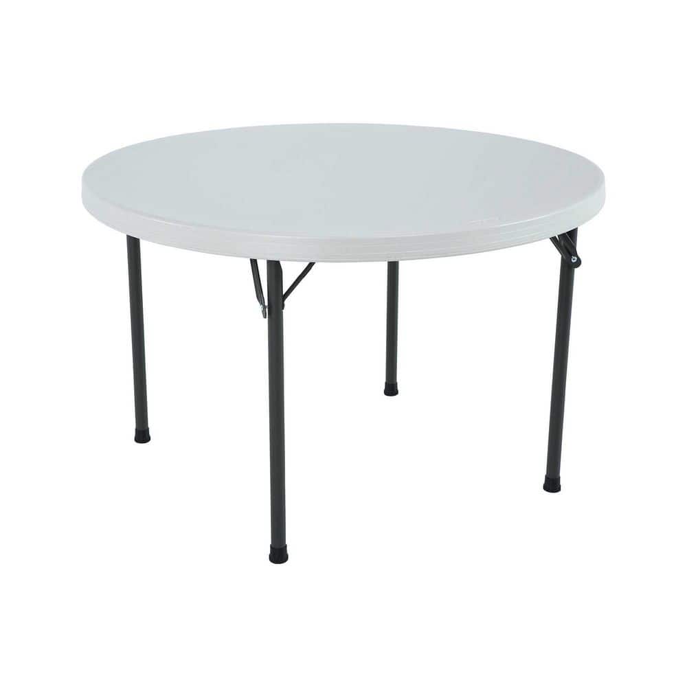 A white round folding card table with grey metal legs.