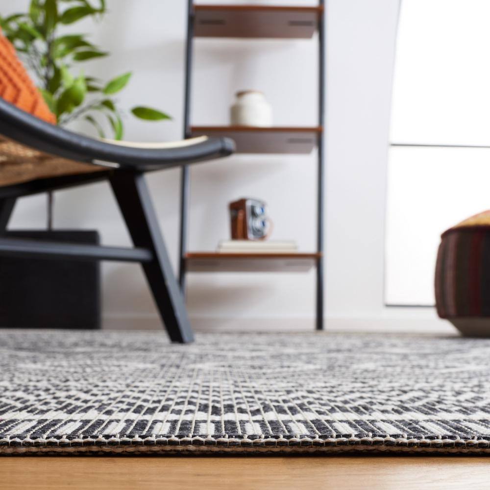 Augustine Black and Ivory Geometric Synthetic Area Rug, 6'4" x 9'6"