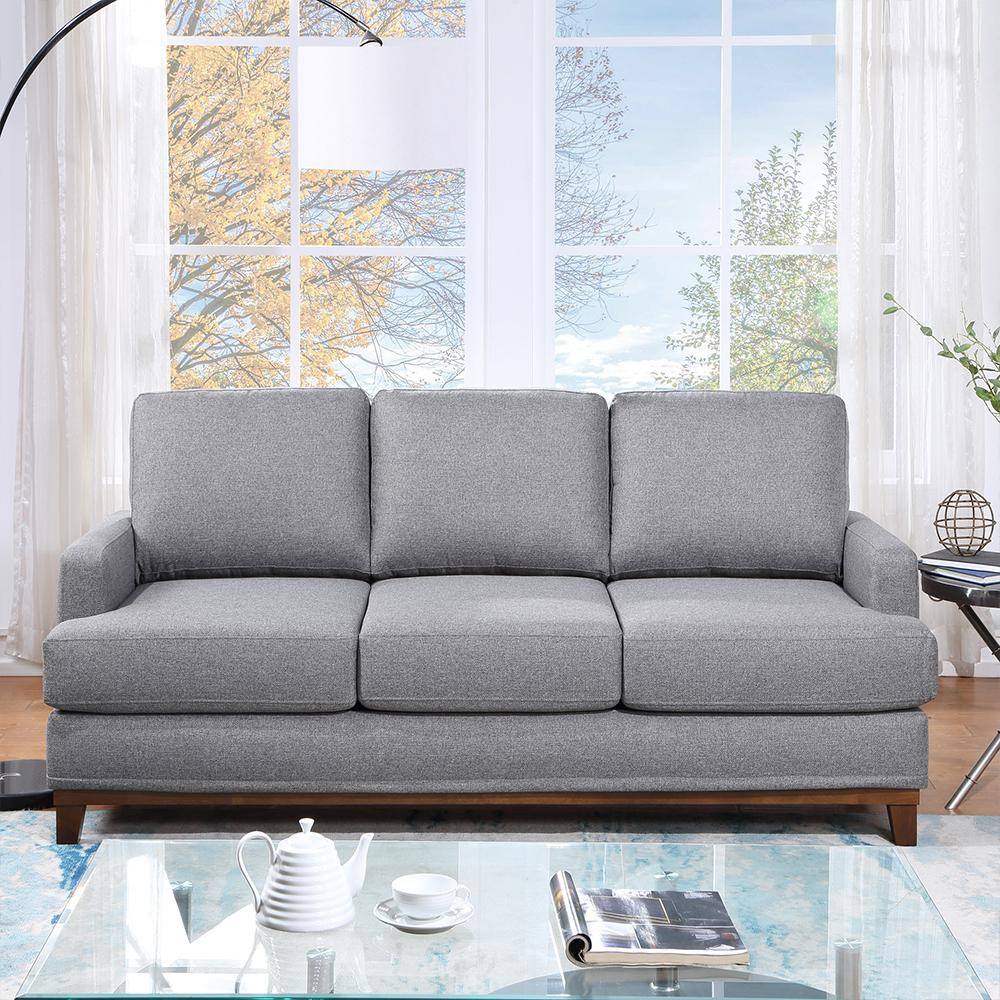 Front view of a gray polyester sofa in a bright living room.