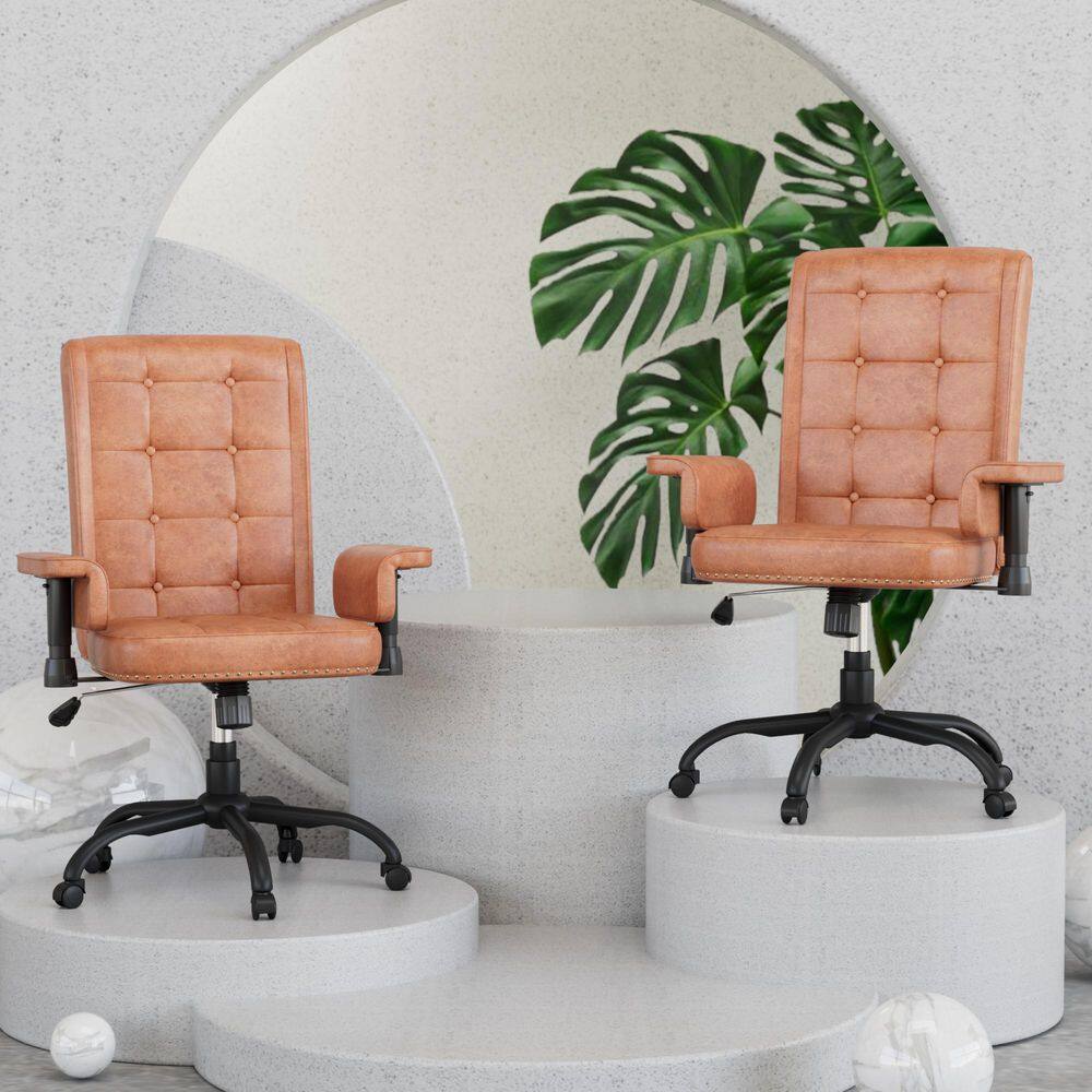 Two brown leather ergonomic office chairs on display pedestals.