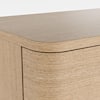 Close-up of the curved edge and wood grain of the coffee table.