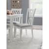 Close-up of a white cross-back chair with a grey seat.