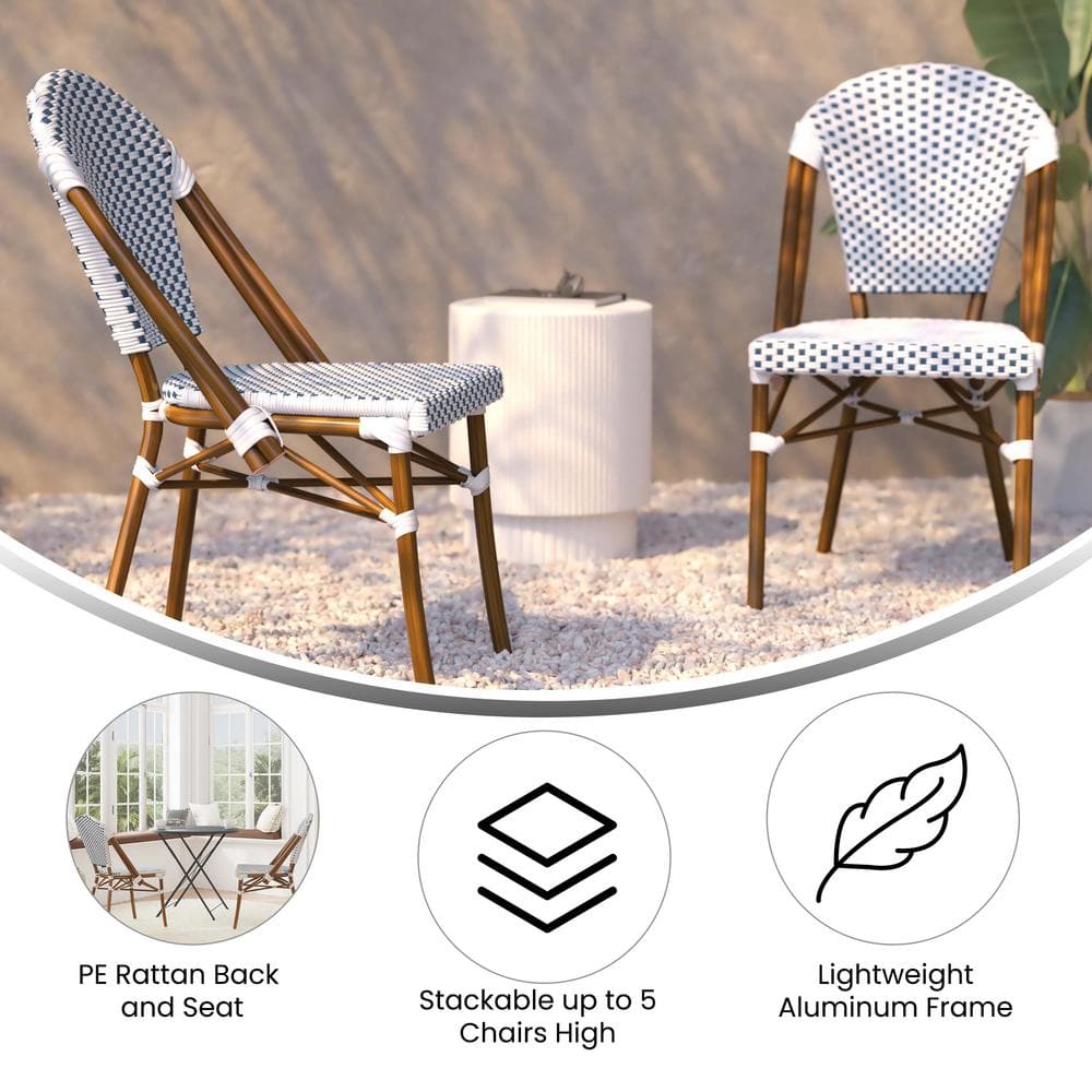 Two white aluminum outdoor dining chairs set outdoors with a white cylindrical object.