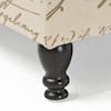 Close-up of a black turned wooden leg of the storage bench.