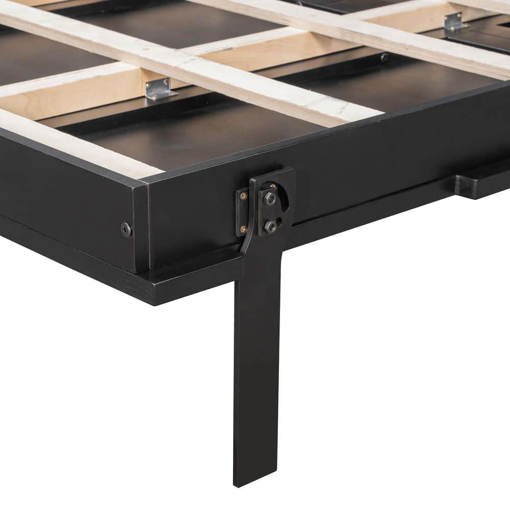 Detail of the bed's black metal leg and wooden slat support system.