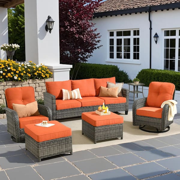 Audrey Gray 6-Piece Wicker Outdoor Patio Conversation Set With Rocking Swivel Chairs and Orange Red Cushions.