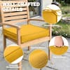 Yellow slipcover cushions on wooden outdoor furniture.