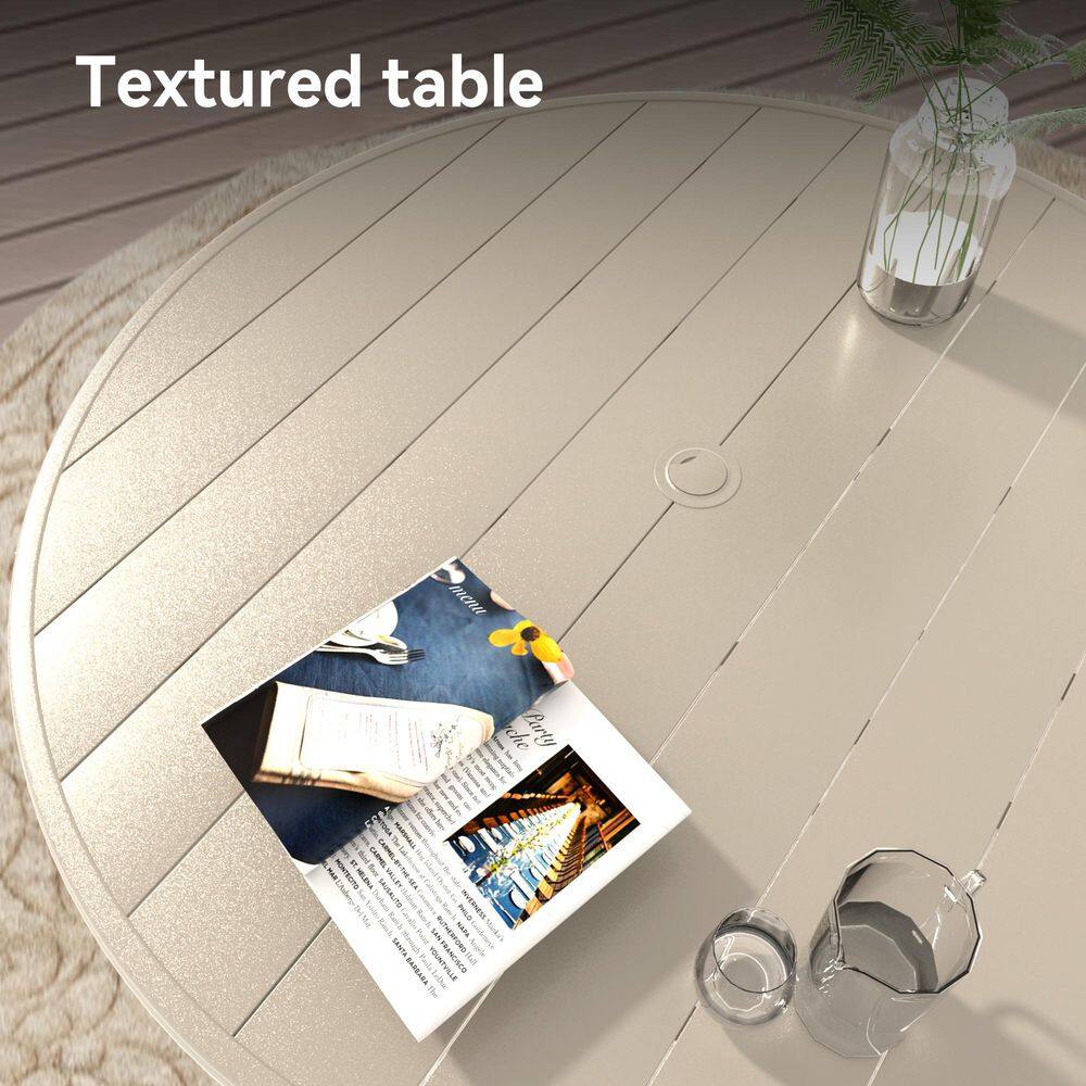 Close-up of the textured surface of the light beige metal outdoor dining table.