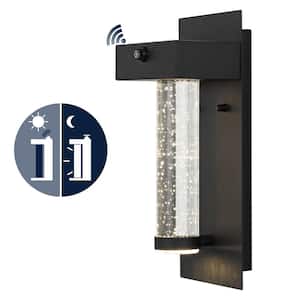 Horizone 5.5 in. Black Hardwired Outdoor Cylinder Sconce Iron/Glass with Dusk-to-Dawn Sensor Integrated LED 1-Light