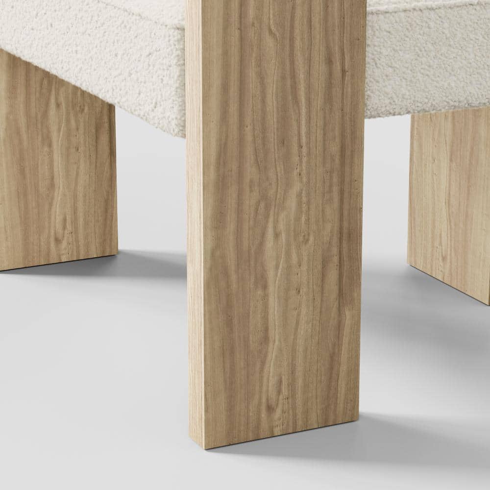 Close-up of the light wood leg of an accent chair.