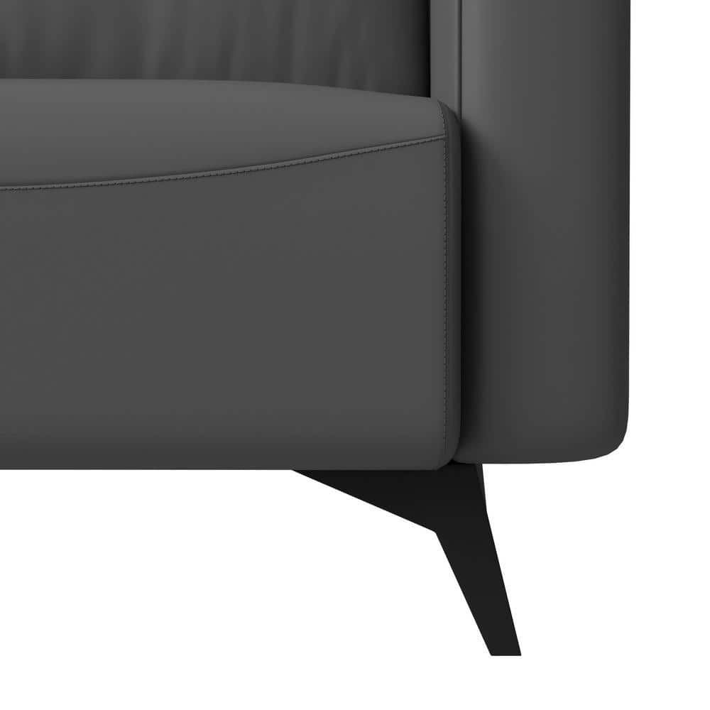 Close-up detail of the upholstery and wooden leg of the chair.