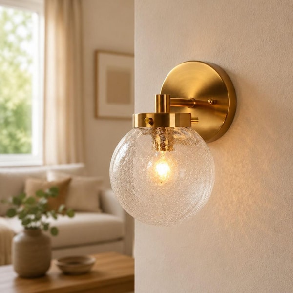 Lunary Modern 5.5 in. 1-Light Brass Globe Wall Sconce with Clear Crackle Glass Shade for Bathrooms and Powder Rooms