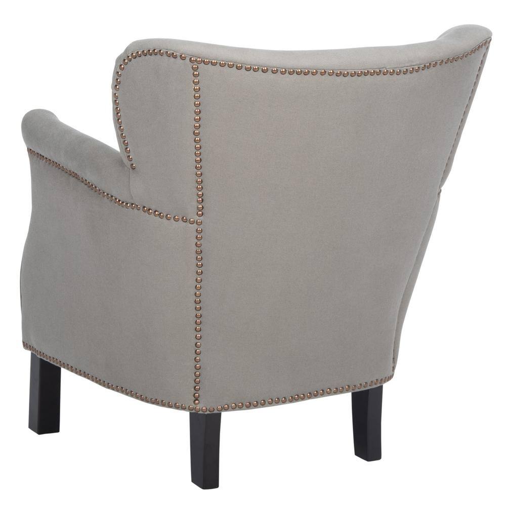 Back view of a light green wingback armchair with nailhead trim.