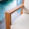 Close-up of the teak armrest and vellum cushion of the lounge chair