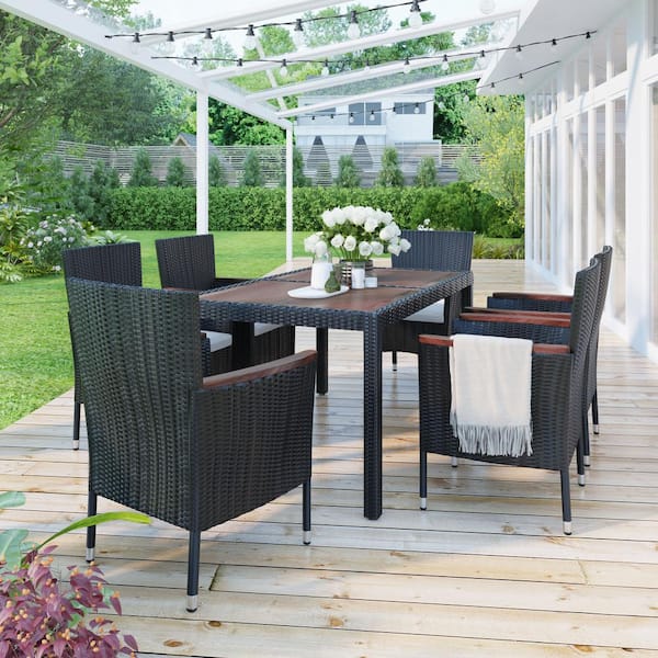Unbranded 7-Piece Reddish-brown Wicker Dining Table and Stackable Armrest Chairs Outdoor Dining Set with White Cushions