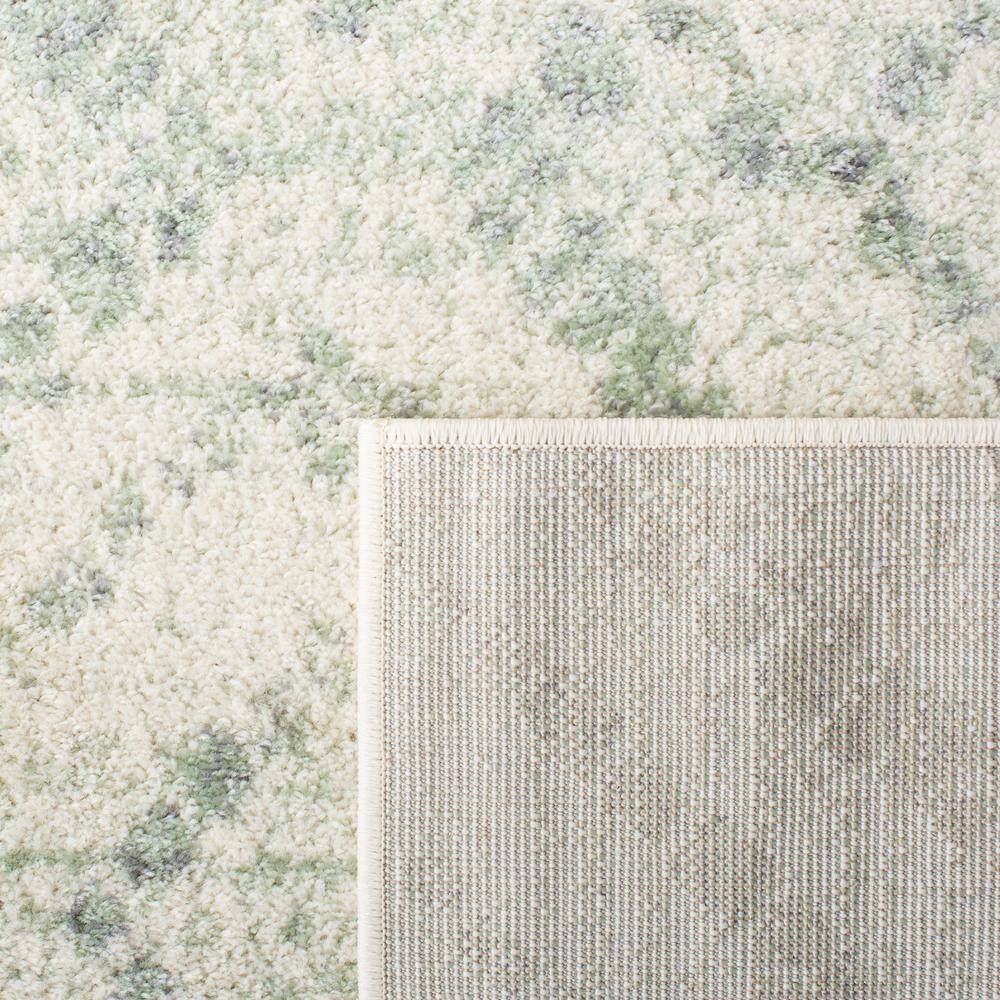 Ivory and Green Geometric 10' x 14' Synthetic Area Rug
