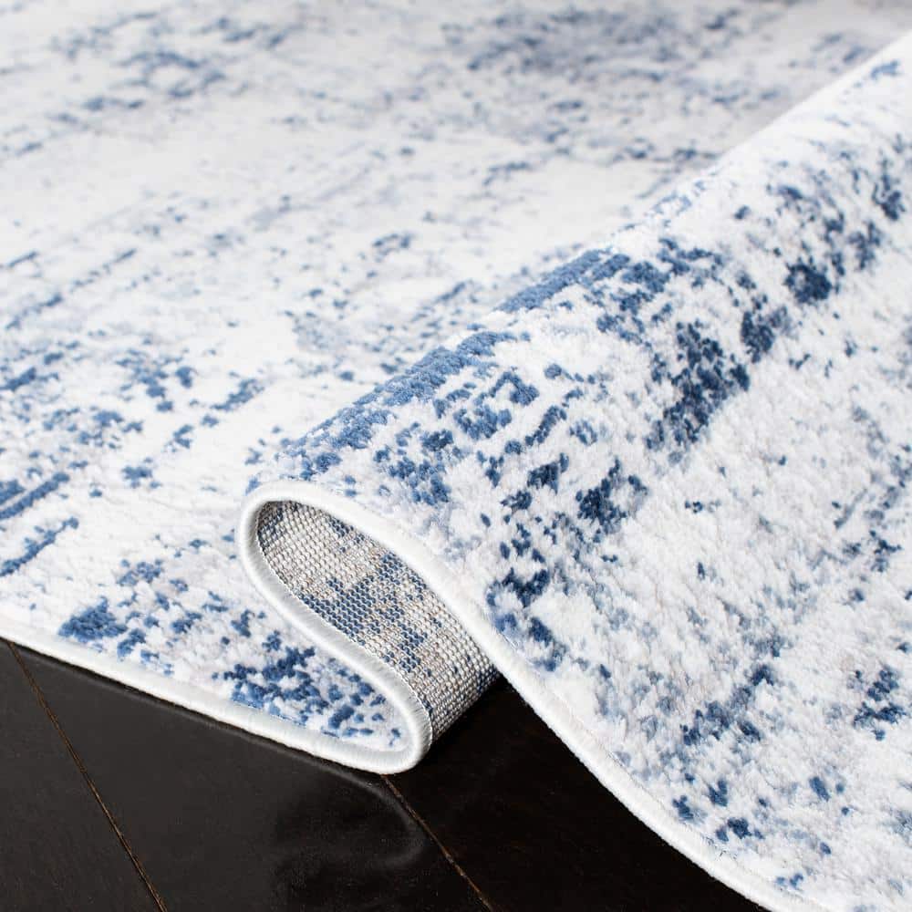 Ivory and Navy Abstract 8' x 10' Synthetic Area Rug