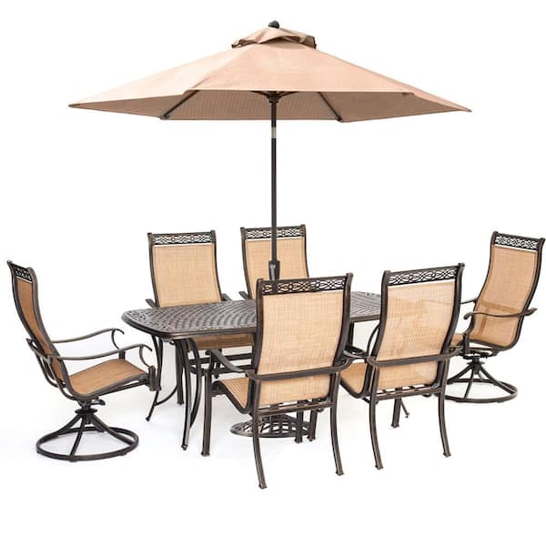 Hanover Manor 7 Piece Sling Outdoor Dining Set With 2 Swivel Rockers 4 Dining Chairs A Cast Top Table Umbrella And Stand Mandn7pcsw 2 Su The Home Depot