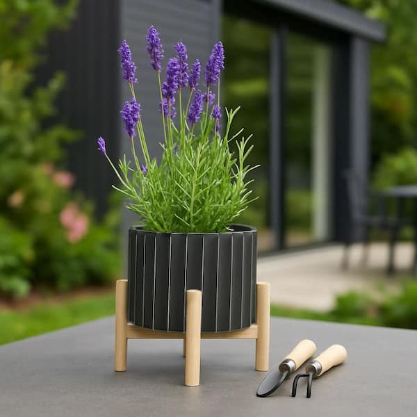 Liv & Skye 8 in. Black Ceramic Fluted Planter with Wood Stand