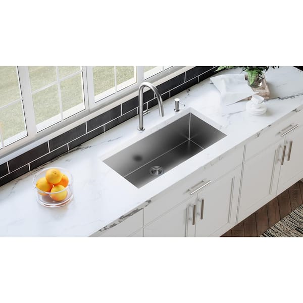 Drain Board built into a granite countertop leading to a bucket sink in a  modern kitchen