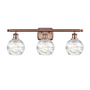 Athens Deco Swirl 26 in. 3-Light Antique Copper Vanity Light with Clear Deco Swirl Glass Shade