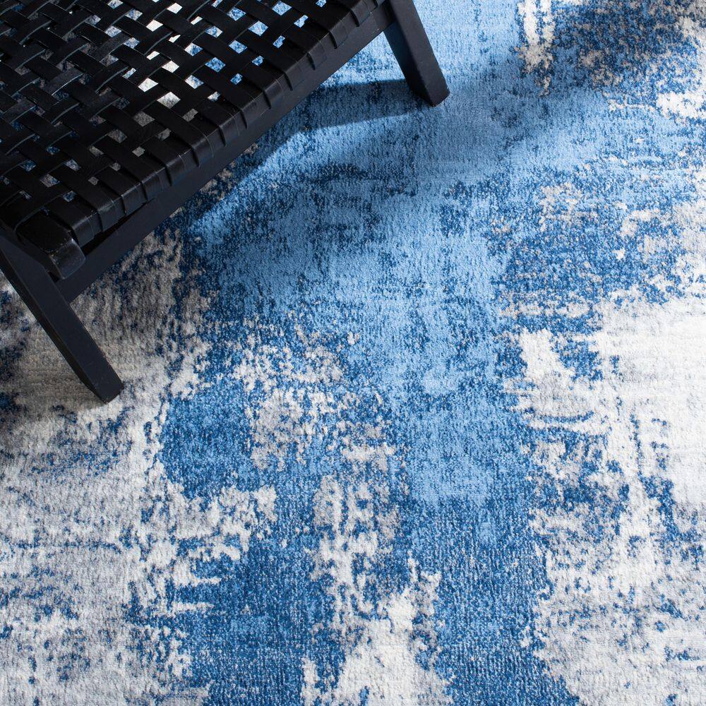 Blue and Ivory Abstract Synthetic Area Rug, 5'3" x 7'6"