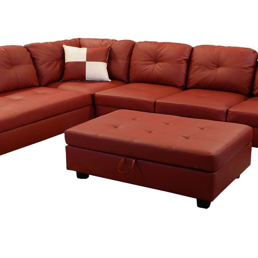 Close-up of a red faux leather sectional sofa's corner and ottoman.