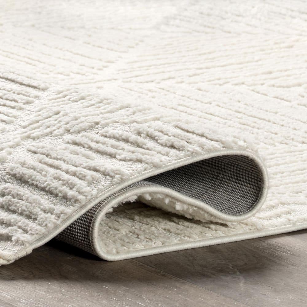 Cream Geometric Textured Synthetic Tasseled Area Rug