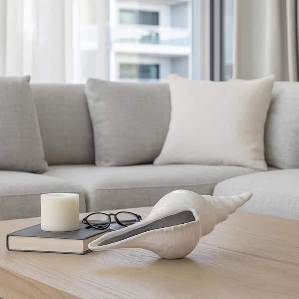 Liv & Skye Ivory 12 in. x 3 in. Stoneware Long Iridescent Seashell With Silver Figurine