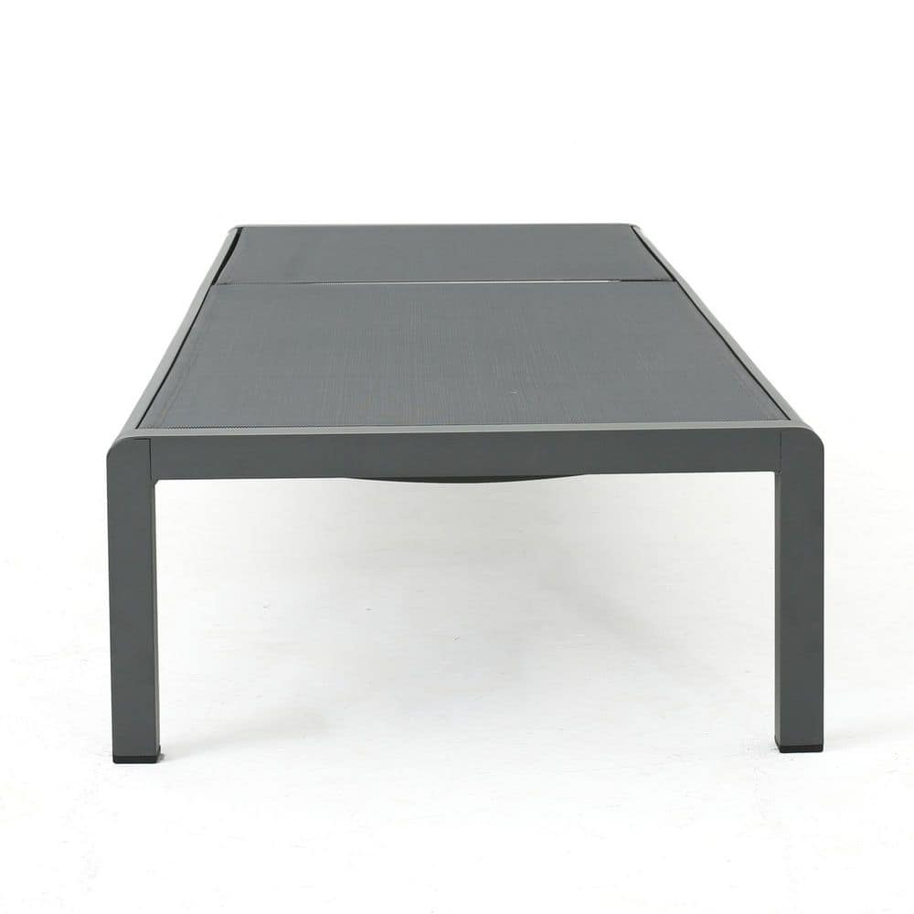 Gray metal outdoor chaise lounge viewed from above.