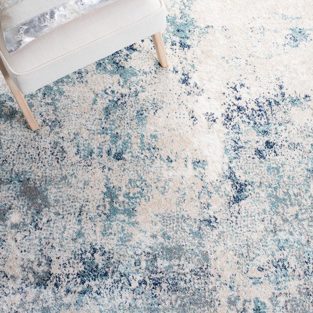 Ivory and Blue Abstract 9' x 12' Stain-Resistant Rug