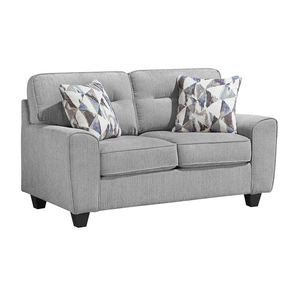 Gray chenille fabric loveseat with geometric accent pillows.