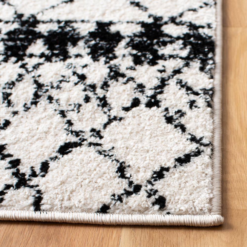 Ivory/Black Synthetic 6' x 9' Hand-Knotted Boho-Chic Area Rug