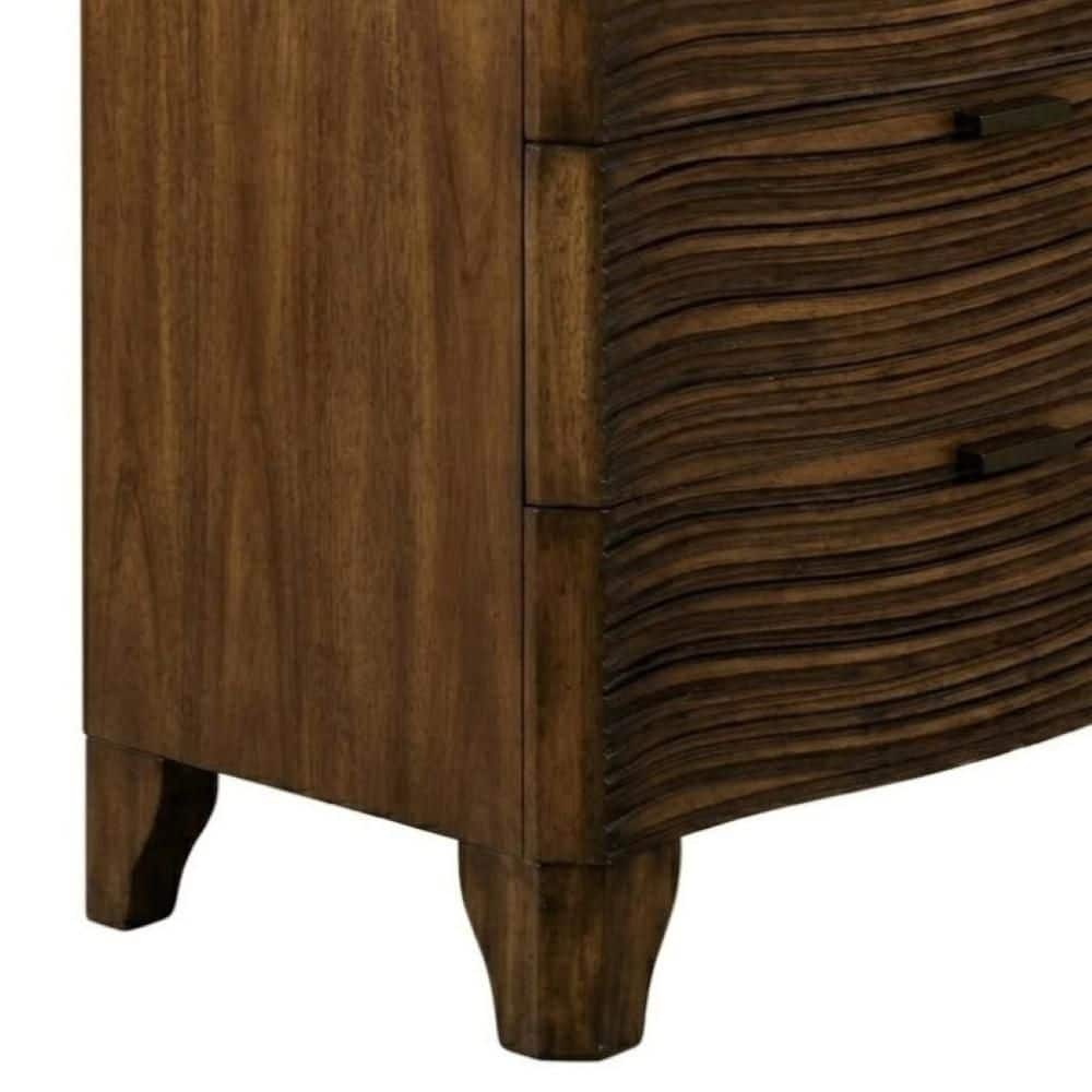 Close-up of the wavy texture on a dark brown cherry wood nightstand drawer.