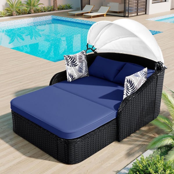 Black Wicker Outdoor Day Bed with Navy Blue Cushions and Adjustable Canopy