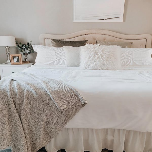white bedding with accent pillows