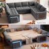 Grey sectional sofa bed with light cover in a living room.